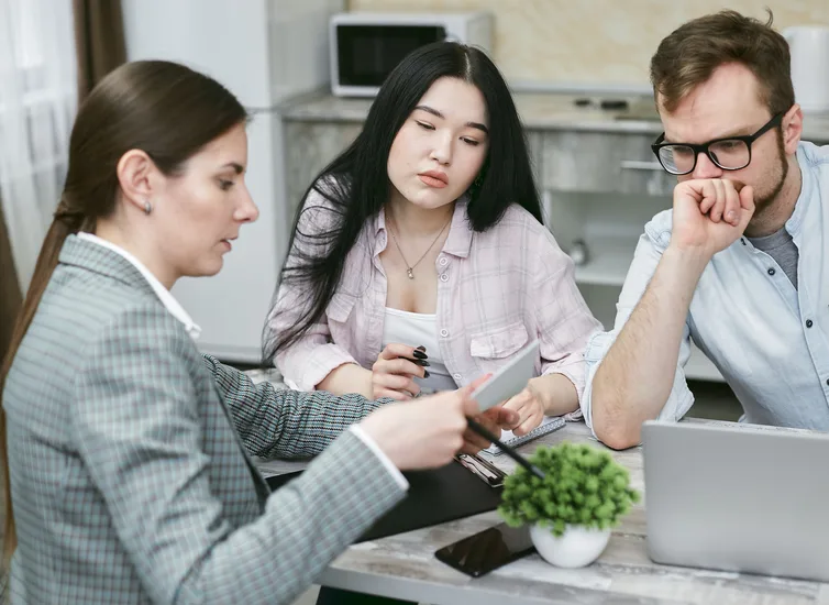 A diverse group of professionals collaborating during an office meeting. A diverse group of professionals collaborating during an office meeting.