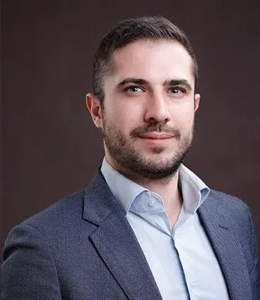 Professional portrait of Peter Kyprianou Peter Kyprianou in a suit posed for a professional headshot.